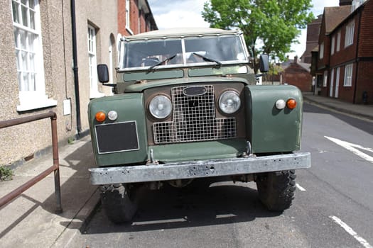 Old green offroad vehicle on the street