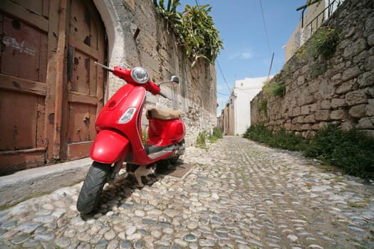 Red stylish italian scooter on the street