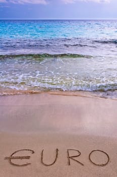 euro word written in the sand on a beach