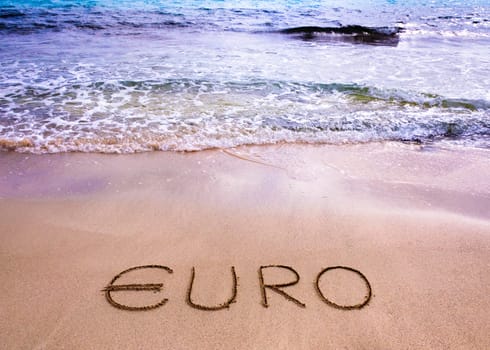 euro word written in the sand on a beach