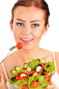 Young woman eating vegetable salad