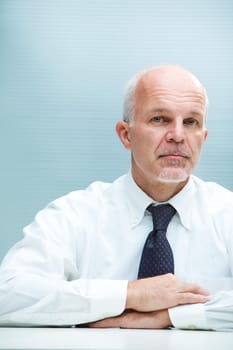 A serious business man staring at camera