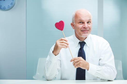 Smiling handsome businessman offering his love