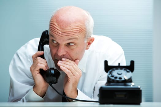Businessman blurting by phone (focus on the man)