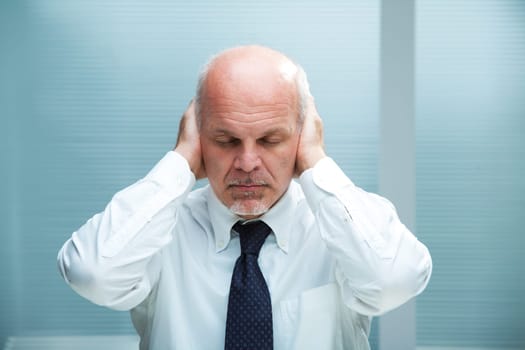 Businessman with the hands on his ears