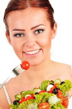 Young woman eating vegetable salad