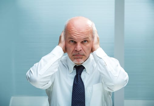 Businessman with the hands on his ears