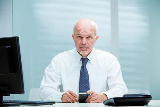 Businessman waiting for you to ask him for something while using his mobile phone