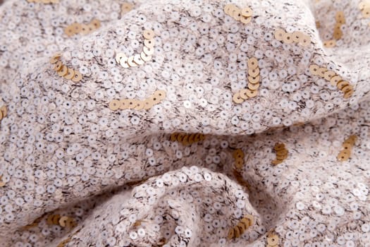 A fancy wrinkled weaved cream with sequin background.