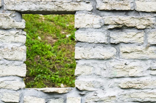 Window aperture in a wall from calcareous stones, a close up