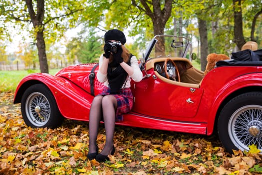 Young woman take picture with car on background