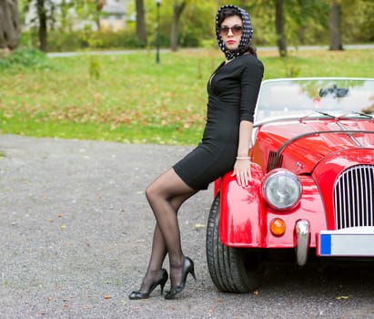 Woman in black with dark glasses with car