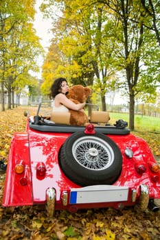 Young woman keep cuddle big soft bear toy