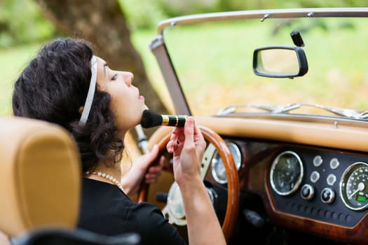 Woman adjust face before mirror at driver seat