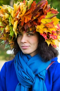 Woman with leaves on head with blue scarf