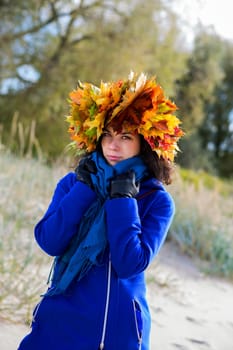 Woman feel cold while walking at autumn park