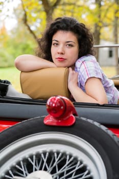Zoomed woman relay at retro car seat back