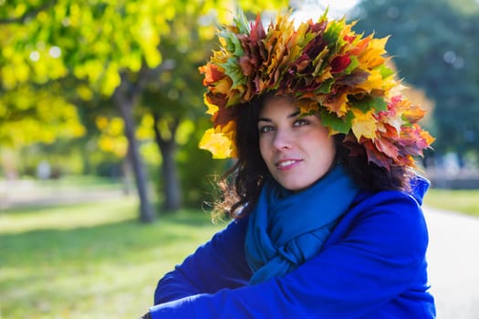 Young woman at sunny autumn day at park