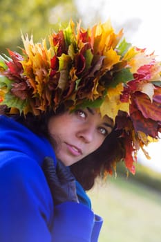 Woman with maple leaves which cover all hairs