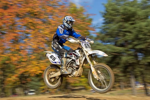 ZABREH, CZECH REPUBLIC - OCT 19.Motocross rider in blue  is jumping at Motocross Zabreh Cup on October 19, 2013 in Zabreh, Czech Republic (Central Europe)