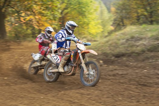 ZABREH, CZECH REPUBLIC - OCT 19. Couple of motocross riders in the turn at Motocross Zabreh Cup on October 19, 2013 in Zabreh, Czech Republic (dynamic shot)