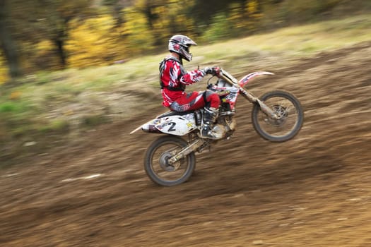 ZABREH, CZECH REPUBLIC - OCT 19.Motocross rider is going uphill. The front wheel is in the air.  Motocross Zabreh Cup on October 19, 2013 in Zabreh, Czech Republic (Central Europe)