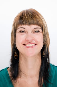 Head-and-shoulder shot of a young woman with a beaming,happily smiling look into the camera