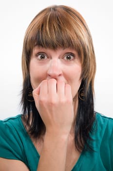 Head-and-shoulder shot of a young woman looking anxiously into the camera and holding her fingernails uncertainly to her mouth