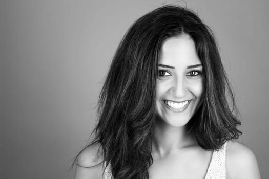 Black and white portrait of a laughing brunette young woman