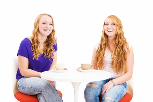 Happy red-haired women having coffee against a white background