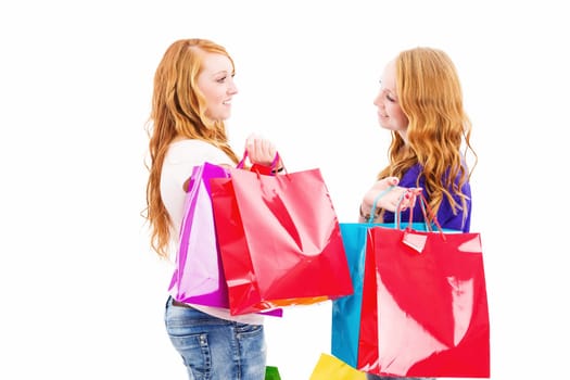 Women with shopping bags talking against a white background