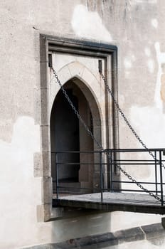 Chain driven gothic door at medieval castle in Europe.