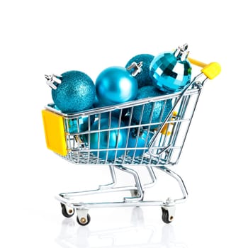 Shopping cart full of christmas balls isolated on white background