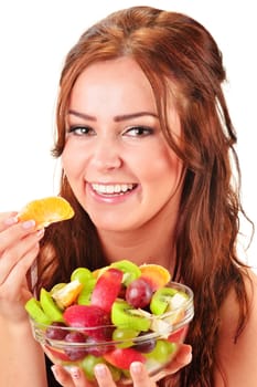 Young woman eating fruit salad