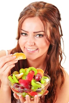 Young woman eating fruit salad