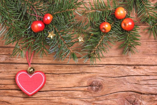 Fir branches with apples and heart pendants