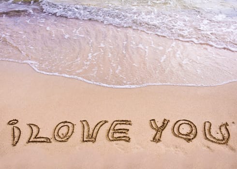 words I Love You written on sand, love concept