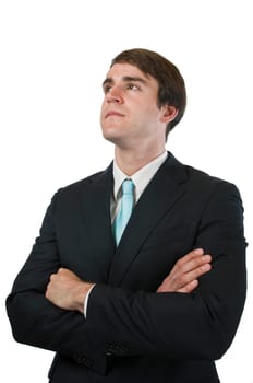 Upper body shot of a young man in a black suit and arms crossed against a white background looking diagonally upwards