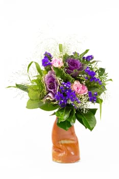 A bouquet of roses,statice and veil herb in a vase