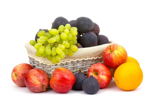 fresh fruits in a basket on white background