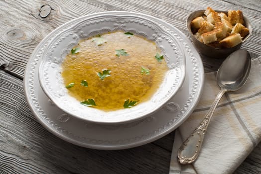 Chicken soup with handmade noodles and bread.