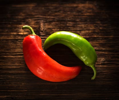 red and green peppers on a wooden table