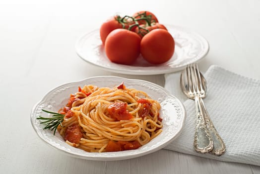 Plate of spaghetti with tomato sauce close up