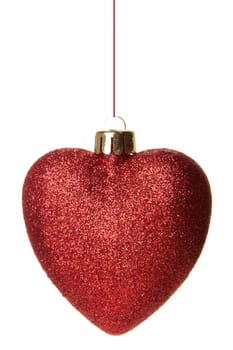 red Christmas bauble with the shape of a heart hanging