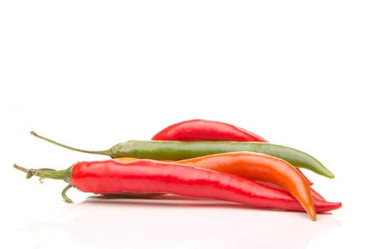 several red and green peppers with white background