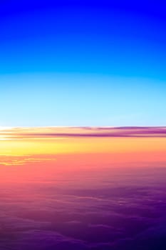sunset with a height of 10 000 km. Dramatic sunset. View of sunset above clouds from airplane window