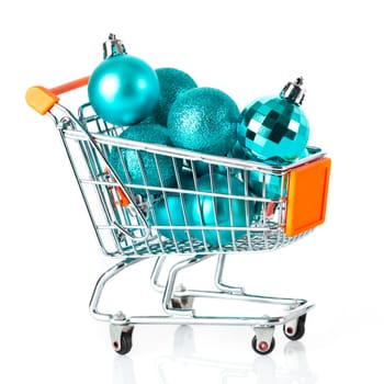 Shopping cart full of christmas balls isolated on white background