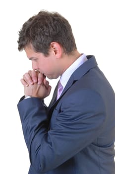 A young businessman praying for a big decision for white background.in a blue suit..