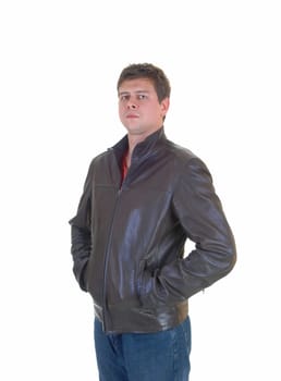 A young handsome man in a brown leather jacket and jeans standing for.white background..