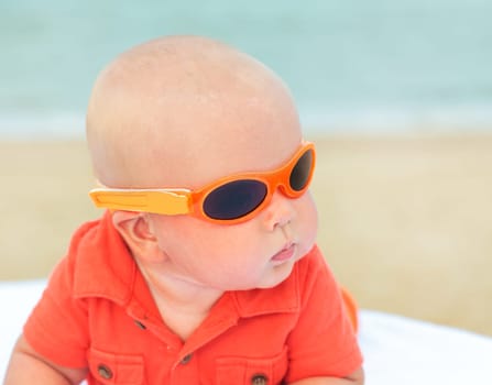 Cute baby laying on the sunbed at the beach